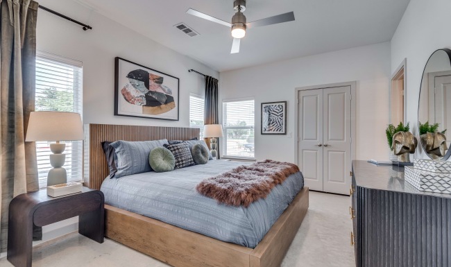 Cozy apartment bedroom with natural light and plush carpet in South Austin.
