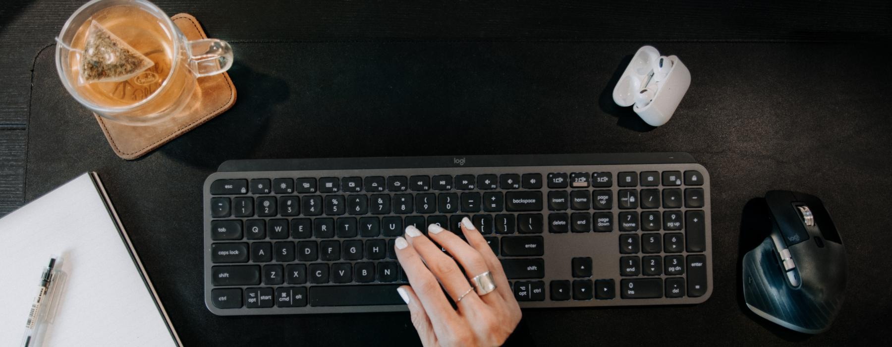 a person typing on a keyboard