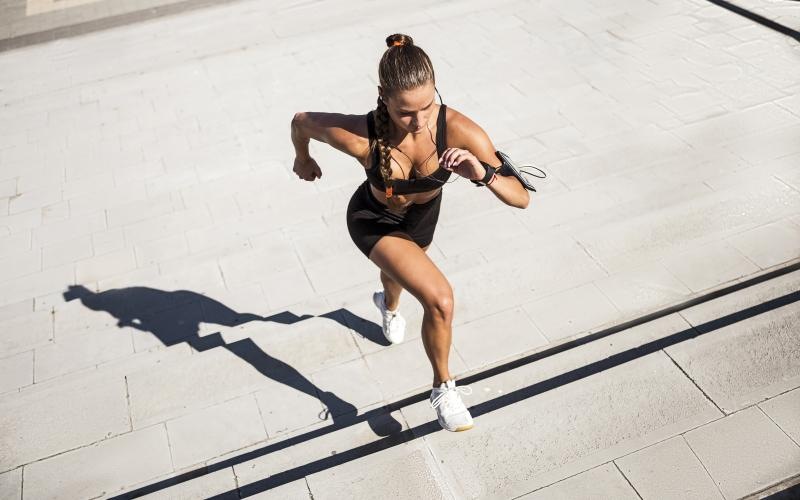 a person running on a sidewalk