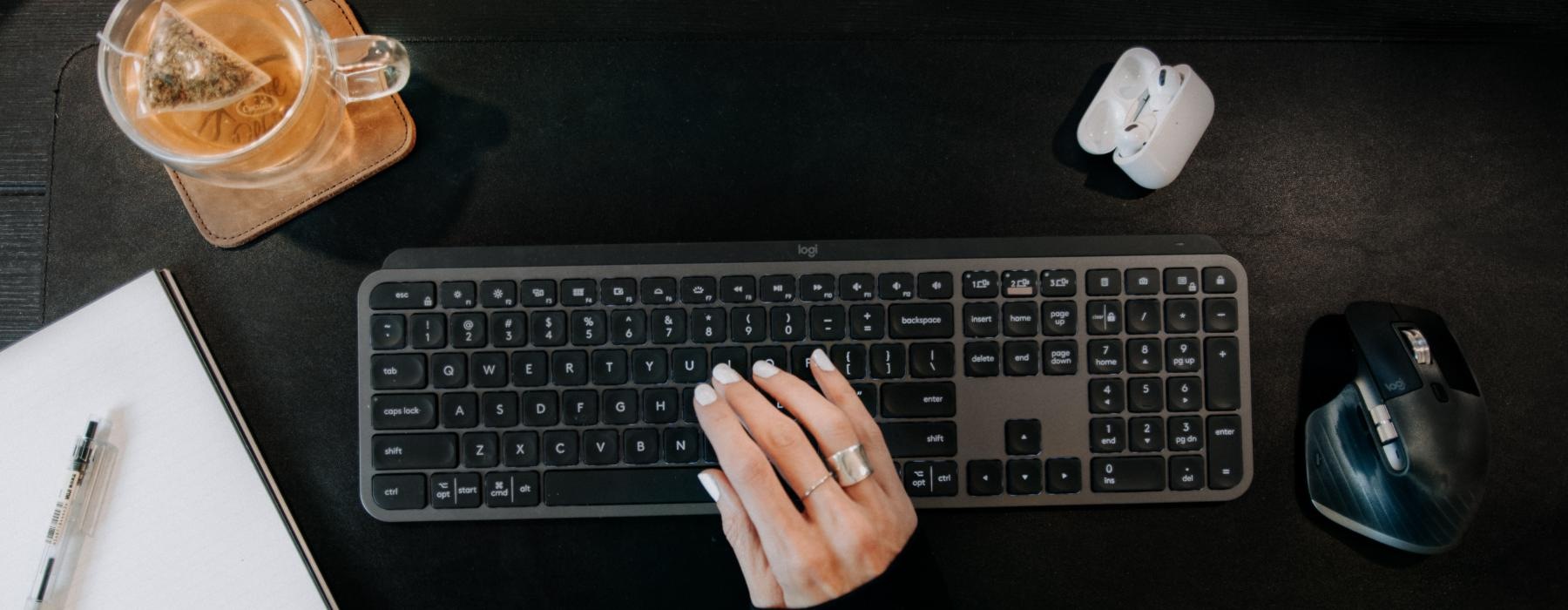 a person typing on a keyboard