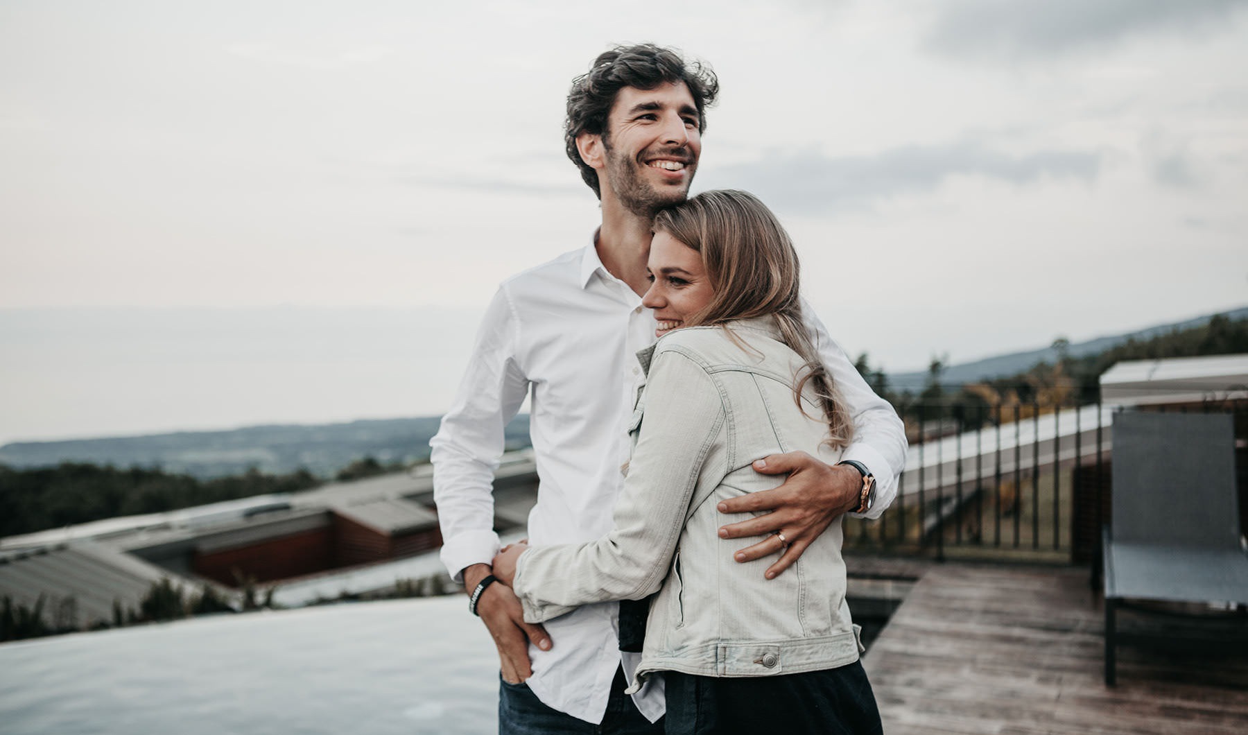 a man and a woman hugging outside